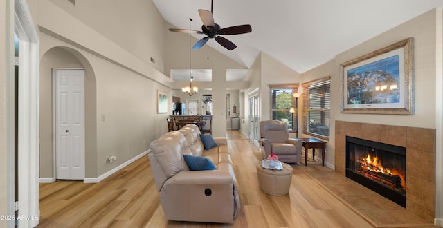 1910 E Citation Ln, Tempe, AZ 85284 - living area with light wood-style floors, ceiling fan, a tile fireplace, a chandelier, and arched walkways