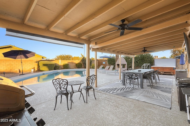 view of patio featuring grilling area, ceiling fan, and a swimming pool with hot tub