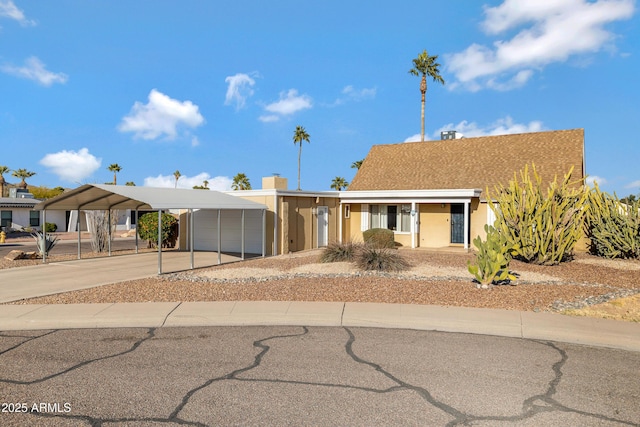 view of front of property featuring a carport and a garage