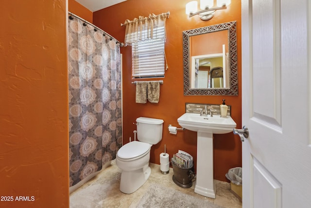 full bathroom with tile patterned floors, toilet, a shower with shower curtain, and a sink