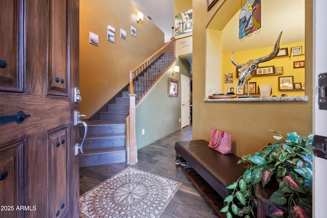 entrance foyer featuring dark wood finished floors and stairs