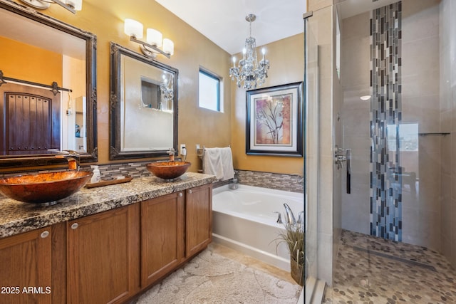 bathroom with a sink, double vanity, a bath, and a shower stall