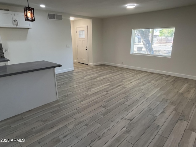 unfurnished living room with light hardwood / wood-style floors