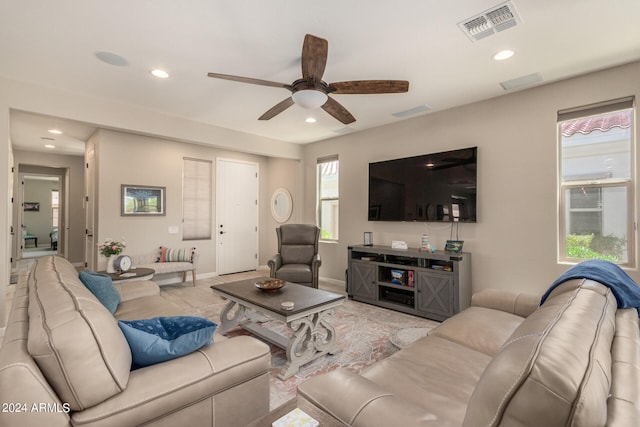 living room featuring light wood-type flooring and ceiling fan