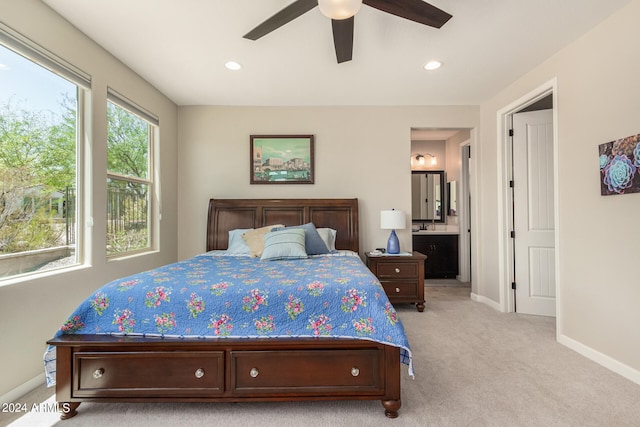 carpeted bedroom featuring connected bathroom and ceiling fan