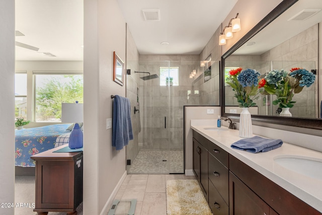 bathroom featuring tile patterned flooring, vanity, and walk in shower