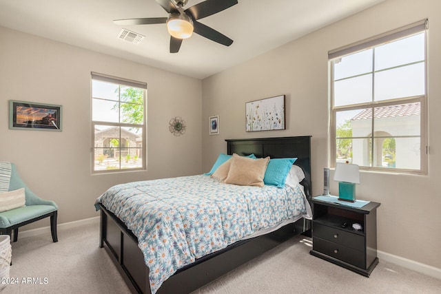 bedroom with light colored carpet and ceiling fan