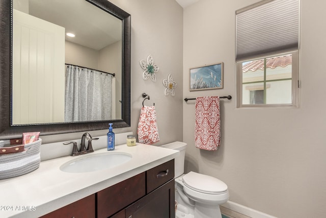 bathroom featuring vanity and toilet