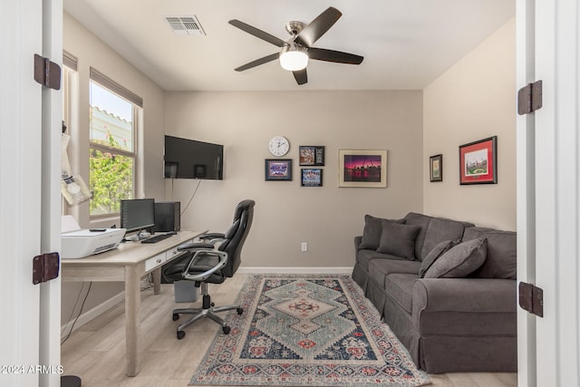 office area with light hardwood / wood-style flooring and ceiling fan