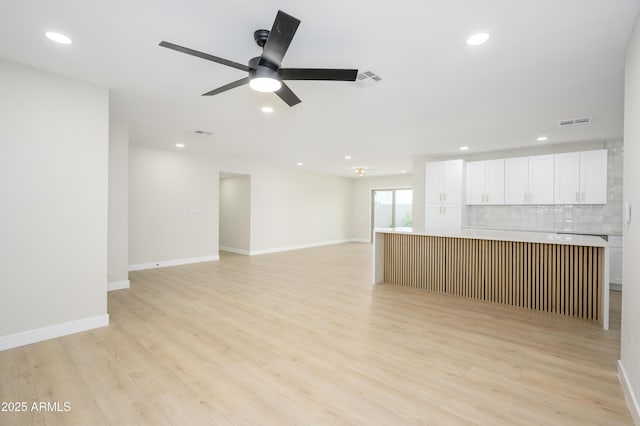 unfurnished living room with visible vents, recessed lighting, ceiling fan, and light wood-type flooring