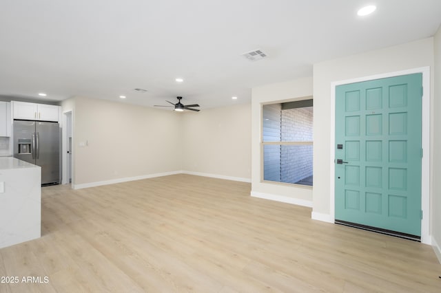 unfurnished living room with a ceiling fan, baseboards, recessed lighting, and light wood-style flooring