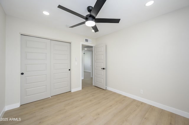 unfurnished bedroom featuring visible vents, light wood-style flooring, baseboards, and recessed lighting