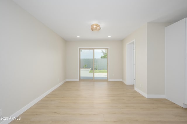spare room with light wood-style floors, baseboards, and recessed lighting