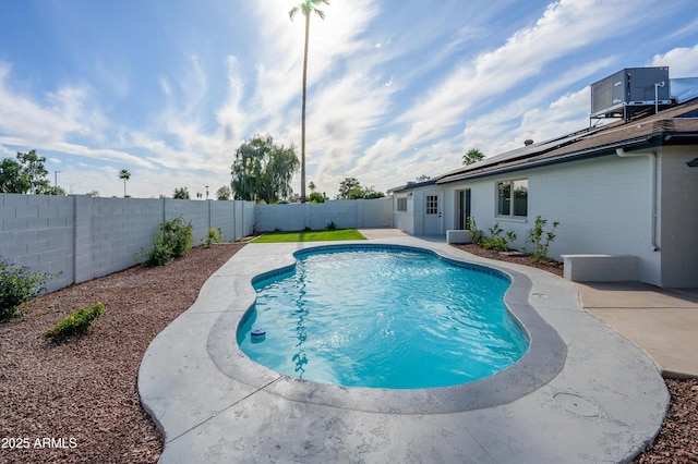 view of pool featuring a fenced in pool, a fenced backyard, central AC, and a patio