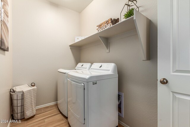 18197 W Cielo Grande Ave, Surprise, AZ 85387 - clothes washing area featuring washer and dryer and light hardwood / wood-style flooring