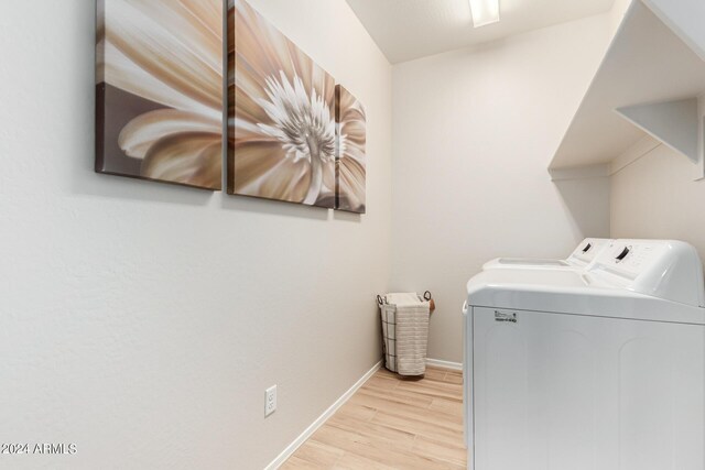 18197 W Cielo Grande Ave, Surprise, AZ 85387 - laundry room featuring light hardwood / wood-style flooring and washing machine and clothes dryer