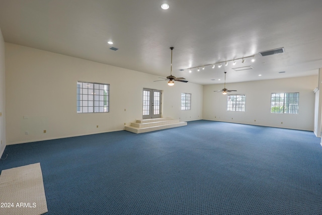 carpeted empty room featuring ceiling fan and rail lighting