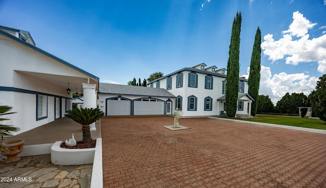 view of front facade with a front yard and a garage