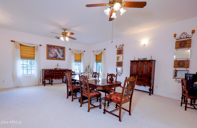 carpeted dining space featuring ceiling fan