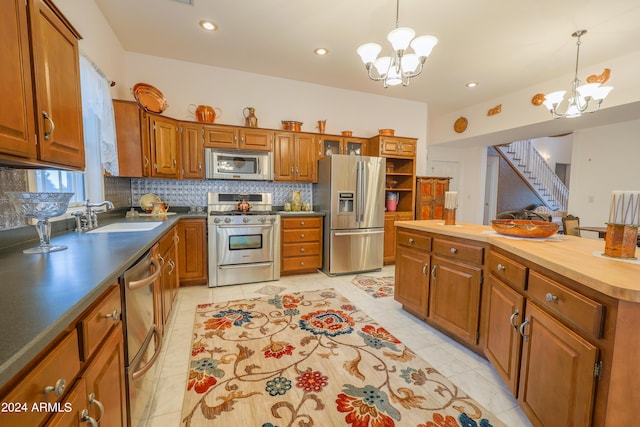 kitchen with sink, decorative light fixtures, stainless steel appliances, a notable chandelier, and butcher block counters