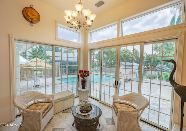 sitting room with an inviting chandelier and light tile patterned flooring