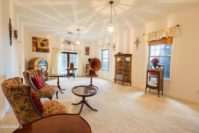 living room with a chandelier and light colored carpet