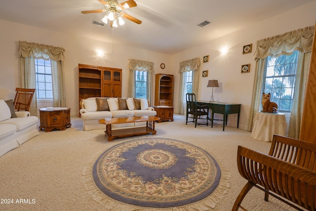 living room featuring carpet floors and ceiling fan