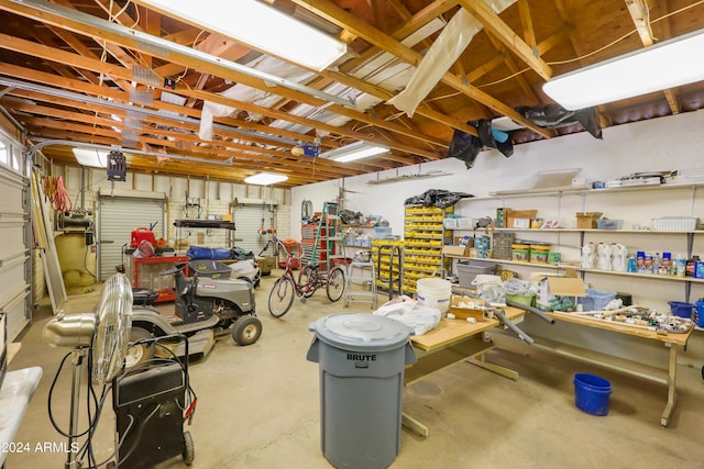 garage with a garage door opener and a workshop area