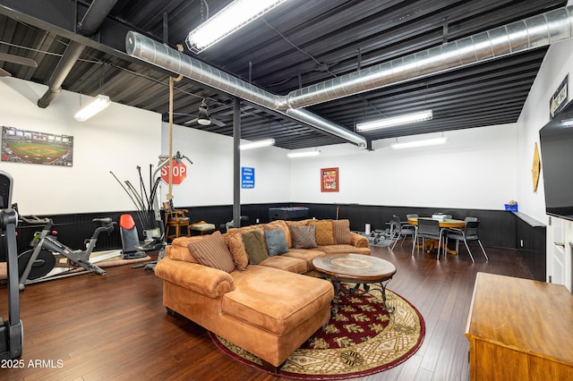 living area featuring a wainscoted wall and hardwood / wood-style floors