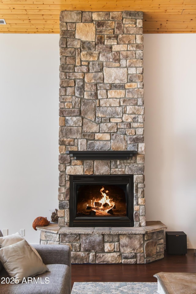 interior details with wood ceiling, a fireplace, and wood finished floors