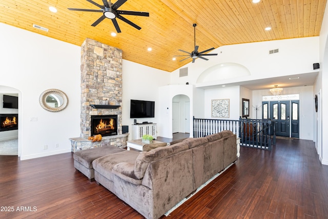 living area featuring wood ceiling, visible vents, and a fireplace