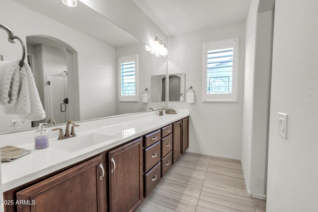 4279 N Spyglass Dr, Florence, AZ 85132 - bathroom with a sink, an enclosed shower, double vanity, baseboards, and tile patterned flooring
