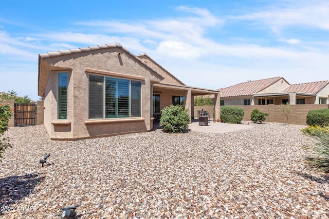 4279 N Spyglass Dr, Florence, AZ 85132 - view of front of property with a patio, a gate, a fenced backyard, and stucco siding