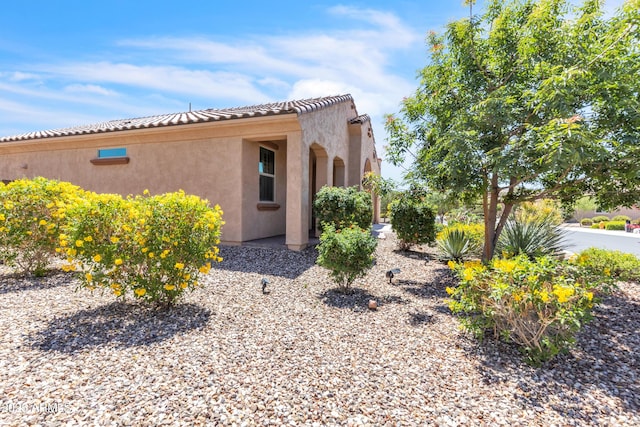 4279 N Spyglass Dr, Florence, AZ 85132 - view of side of home with stucco siding and a tiled roof