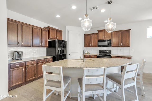 4279 N Spyglass Dr, Florence, AZ 85132 - kitchen featuring black appliances, recessed lighting, visible vents, and decorative backsplash
