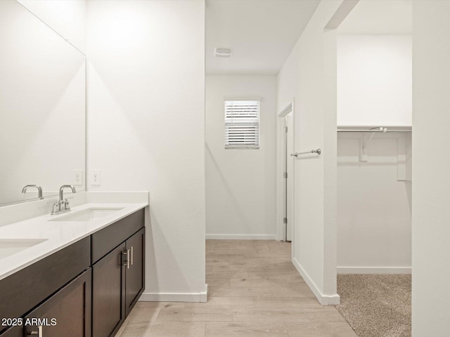 bathroom with vanity and wood-type flooring