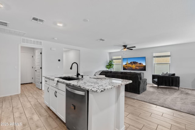 654 E Buckingham Ave, Gilbert, AZ 85297 - kitchen with stainless steel dishwasher, wood finish floors, ceiling fan, open floor plan, and white cabinets