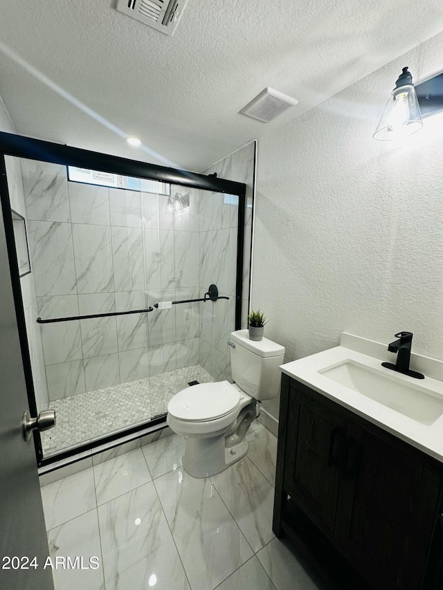 bathroom with walk in shower, vanity, a textured ceiling, and toilet