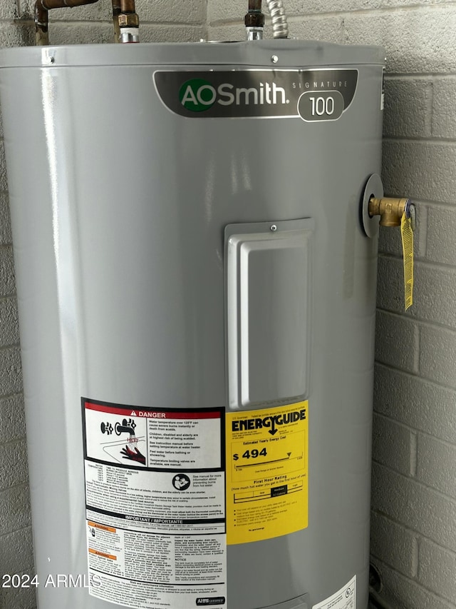 utility room featuring electric water heater