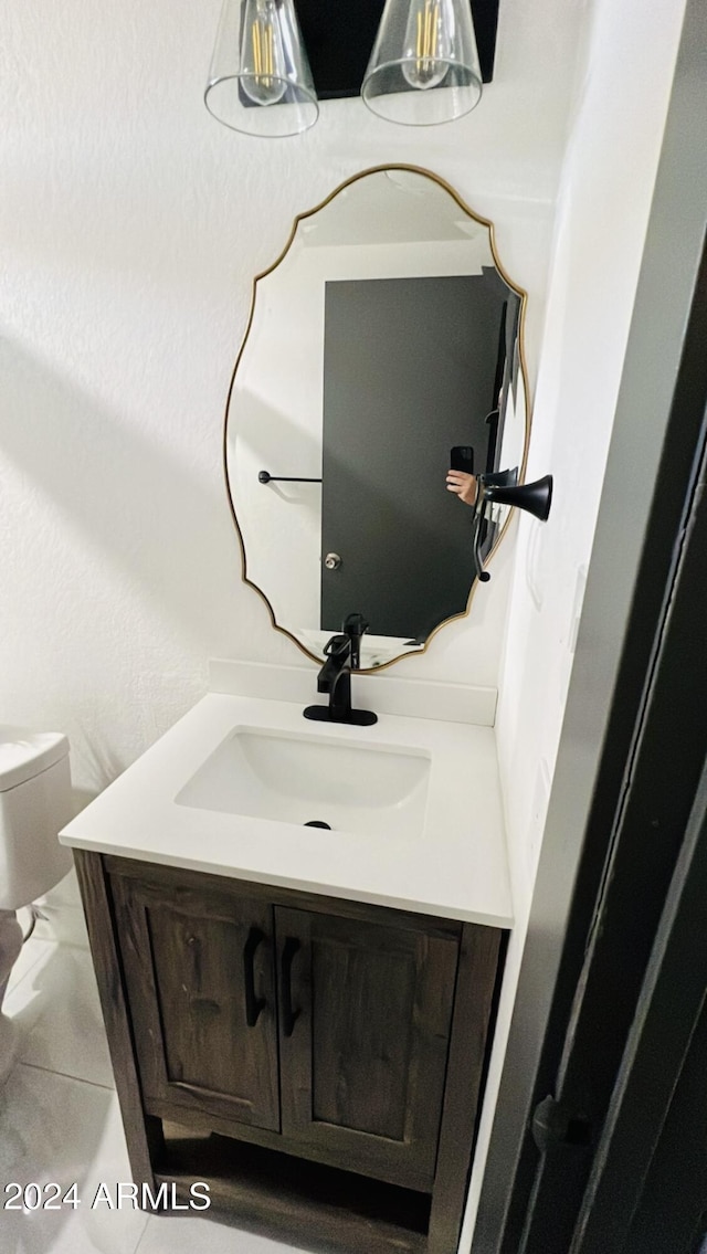 bathroom featuring tile patterned floors, vanity, and toilet