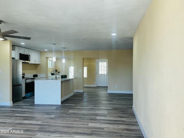 kitchen featuring white cabinetry, sink, stainless steel appliances, dark hardwood / wood-style flooring, and decorative light fixtures