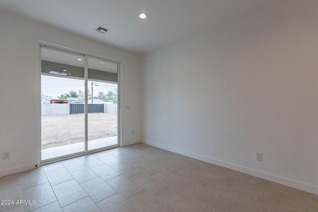 spare room featuring light tile patterned floors