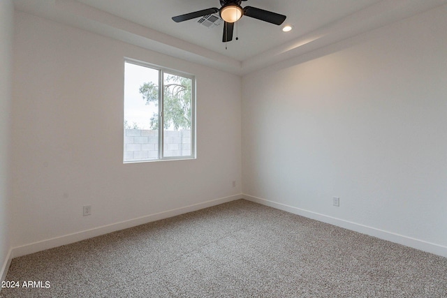 carpeted spare room featuring ceiling fan