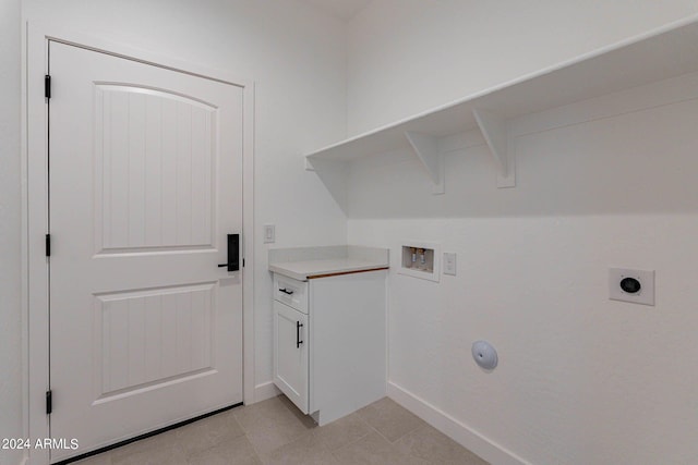 washroom with light tile patterned flooring, washer hookup, and hookup for an electric dryer