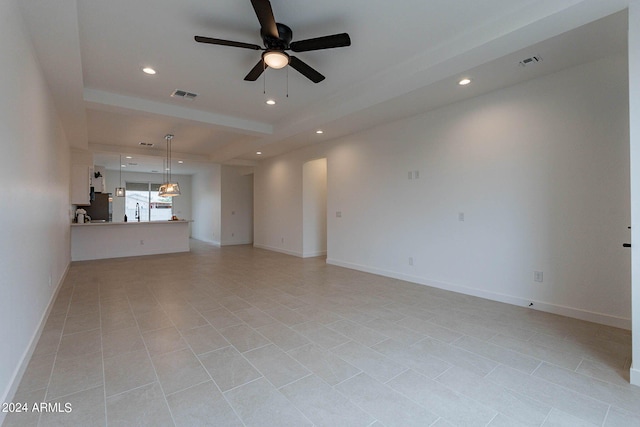 unfurnished living room featuring light tile patterned flooring, sink, and ceiling fan