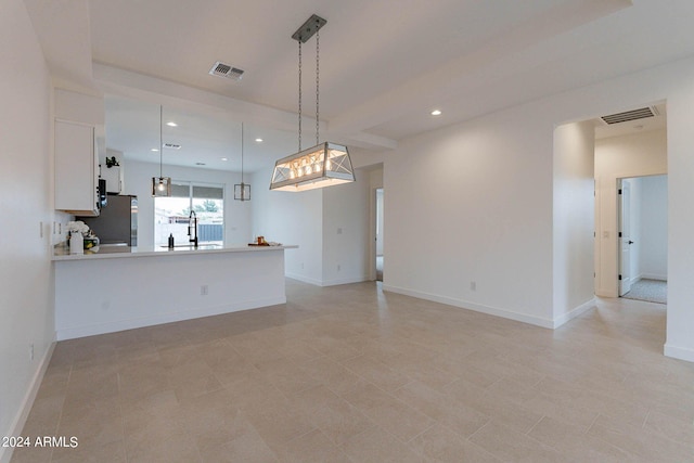 unfurnished living room featuring sink