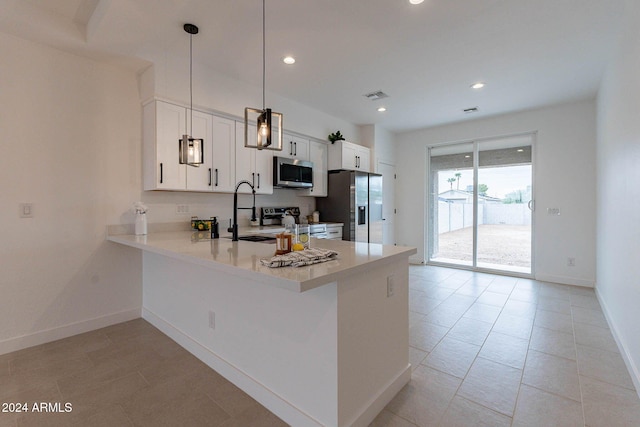 kitchen featuring sink, kitchen peninsula, hanging light fixtures, white cabinetry, and stainless steel appliances