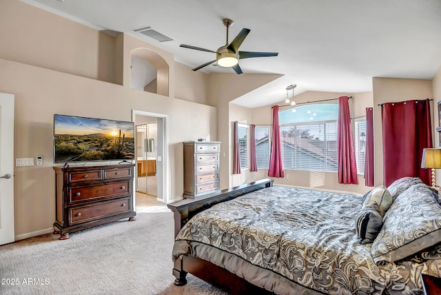 carpeted bedroom with lofted ceiling, connected bathroom, and ceiling fan