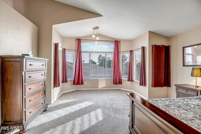 carpeted bedroom with vaulted ceiling