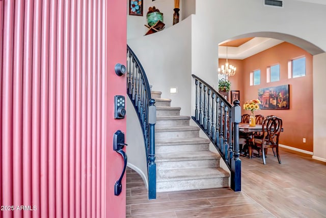 stairs featuring an inviting chandelier